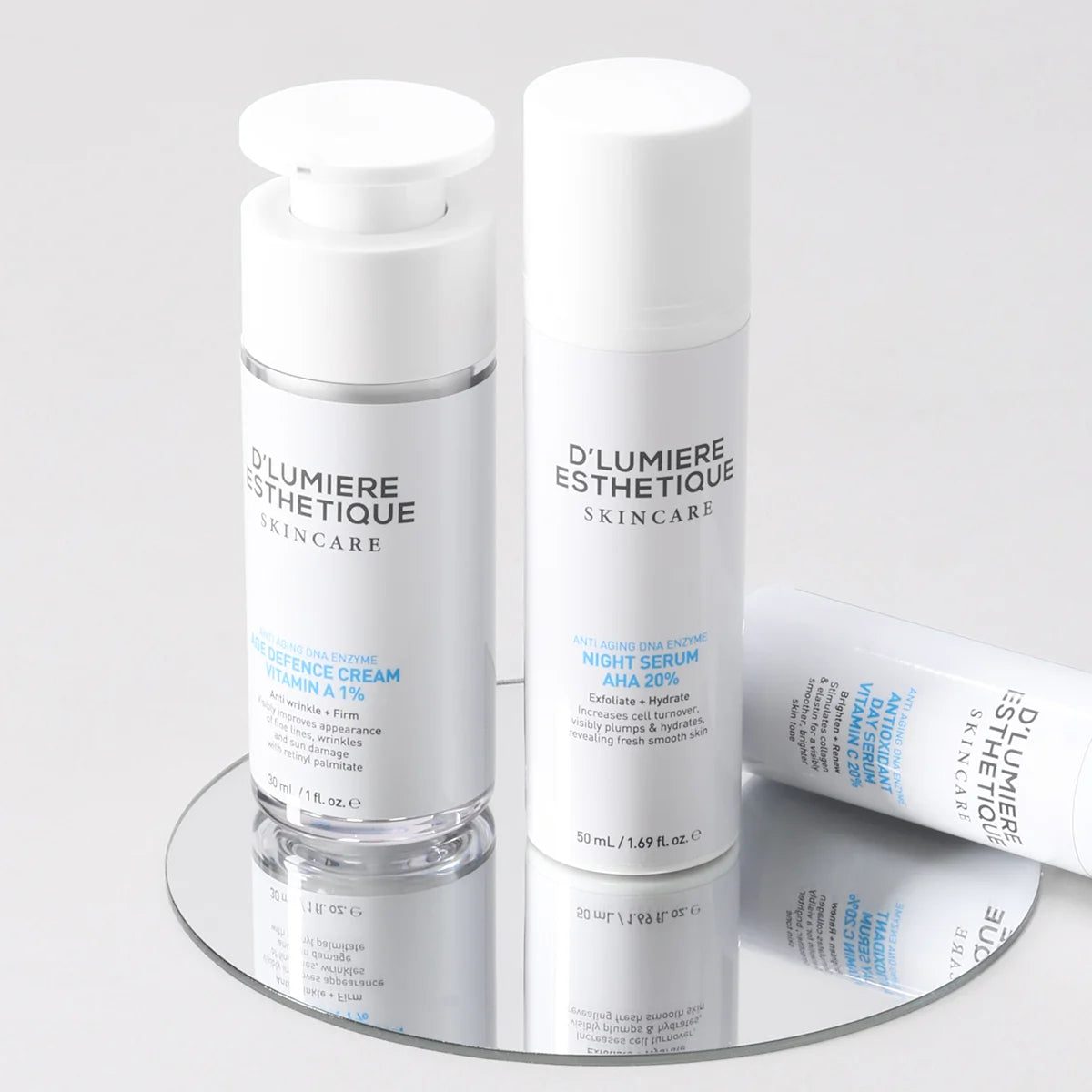 D'lumiere Esthétique skincare products on a reflective surface with a light gray background