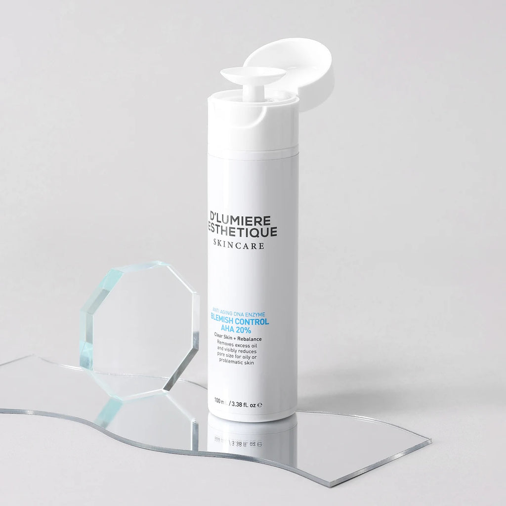 Skincare bottle with 'D'Lumiere Esthetique' branding on a clear stand against a light gray background