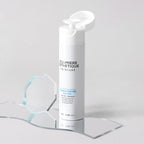 Skincare bottle with 'D'Lumiere Esthetique' branding on a clear stand against a light gray background