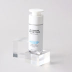 Skincare serum bottle on a clear stand with a white background