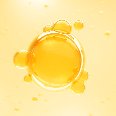 Yellow liquid droplet on a yellow background