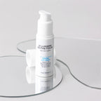 Skincare cream bottle with 'D'Lumiere Esthetique' branding on a clear glass stand.