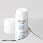 Two skincare cream jars with 'D'Lumiere Esthetique' branding on a gray background